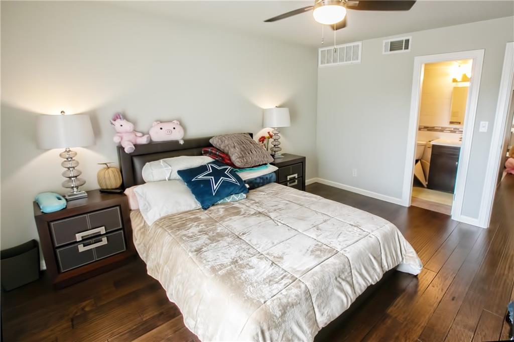 3110 Red River Street, Unit D315 Austin, TX 78705 - Photo 7 of 12 a bedroom with a bed and wooden floor