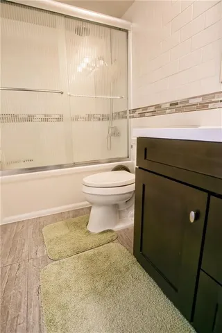 a bathroom with a toilet and a shower