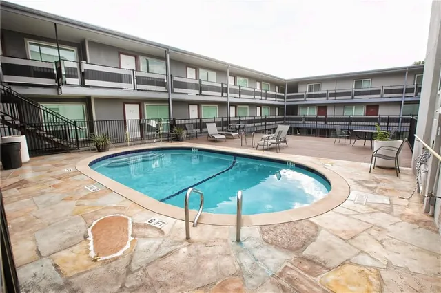 a swimming pool with outdoor seating yard and barbeque oven