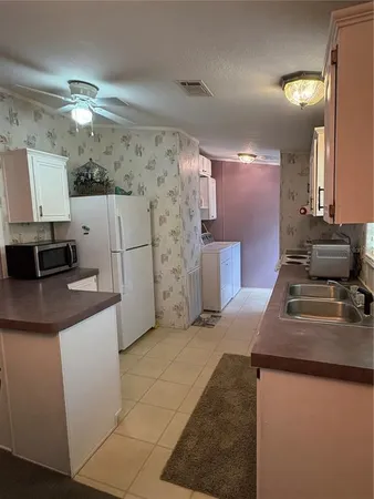 a kitchen with kitchen island granite countertop a sink window and cabinets