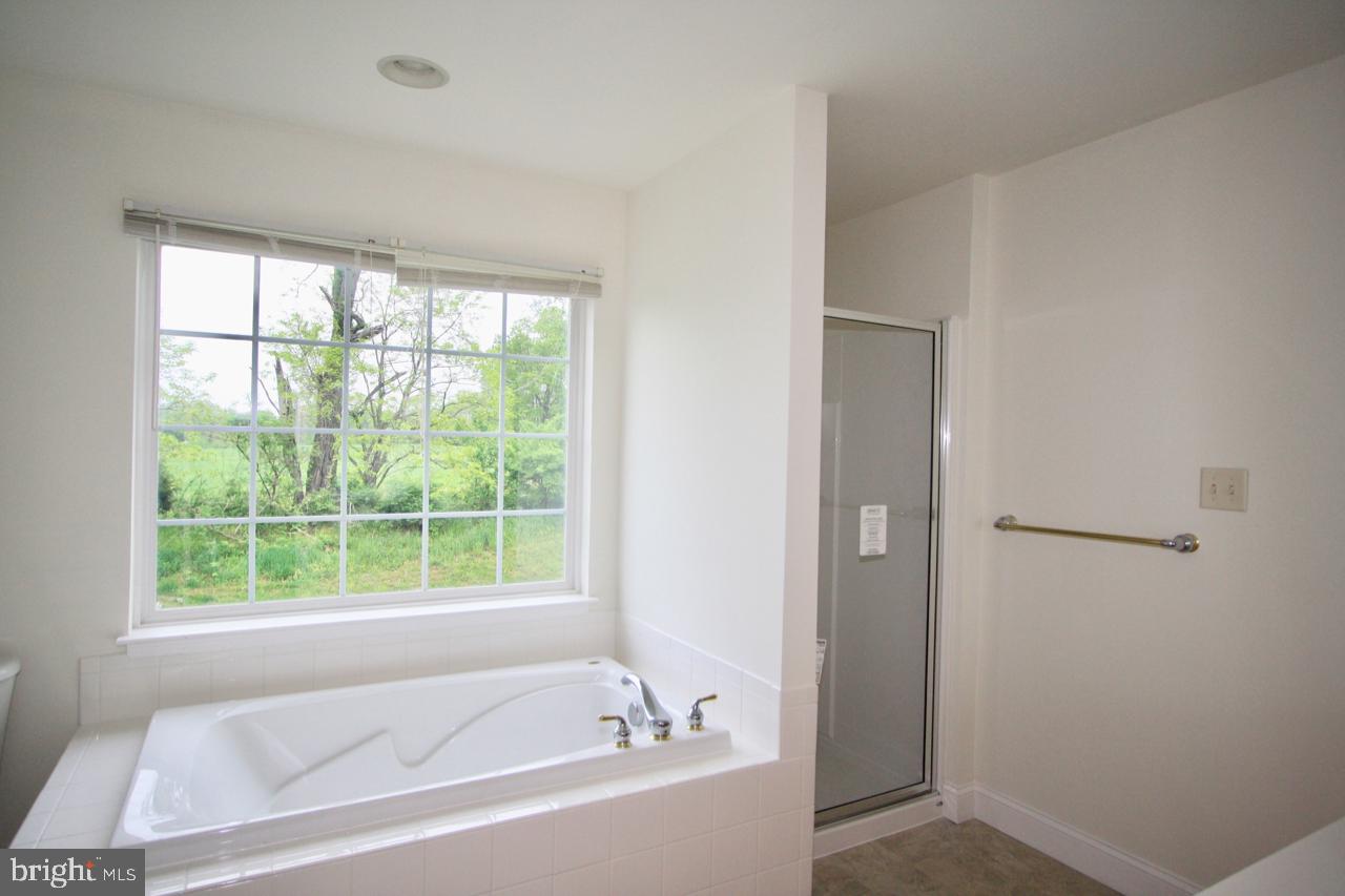17626 Potter Bell Way Hagerstown, MD 21740 - Photo 15 of 21 a white bath tub sitting next to a window
