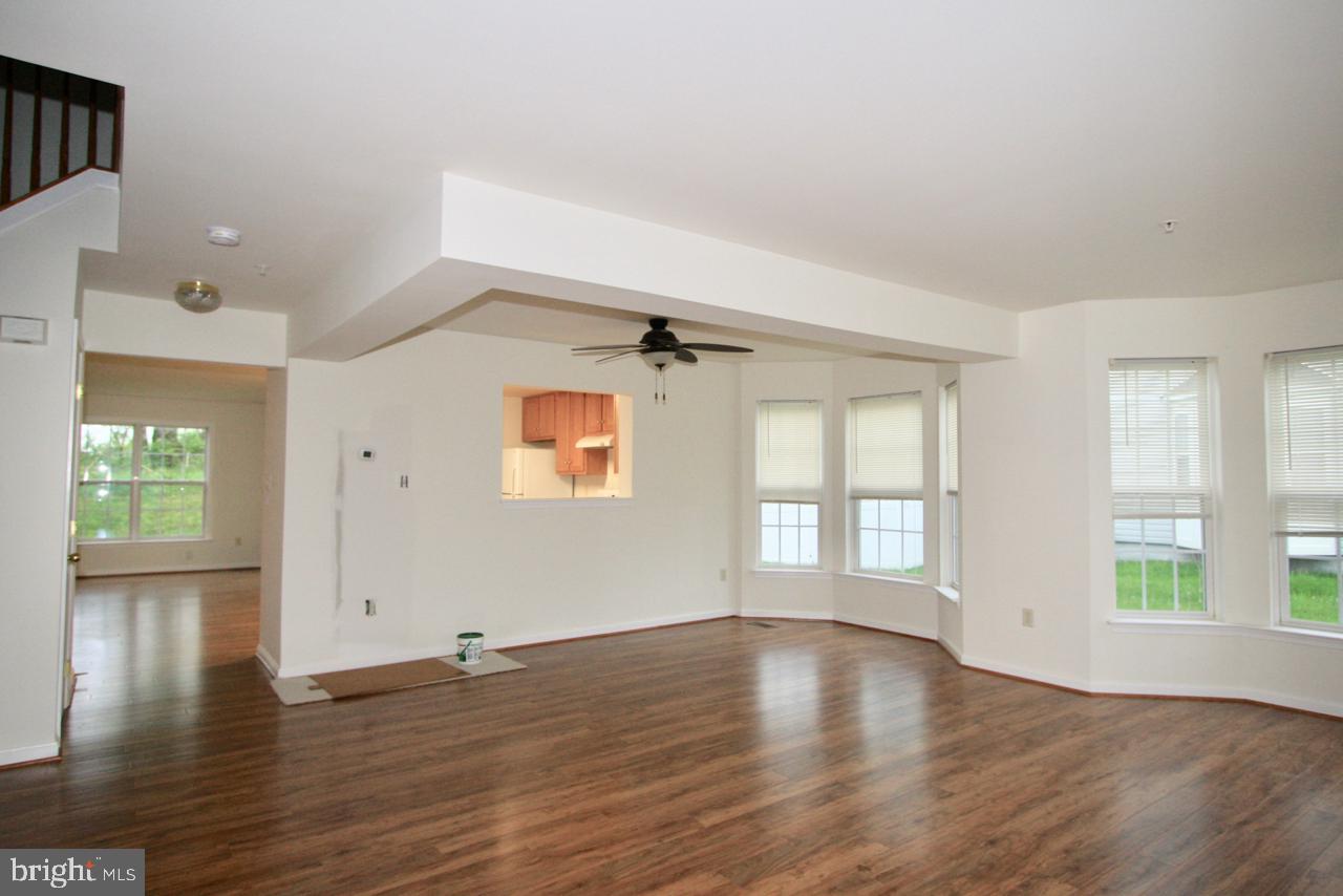 17626 Potter Bell Way Hagerstown, MD 21740 - Photo 2 of 21 an empty room with wooden floor and windows