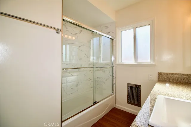 a bathroom with a tub and shower