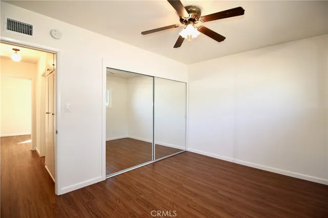 an empty room with wooden floor and door