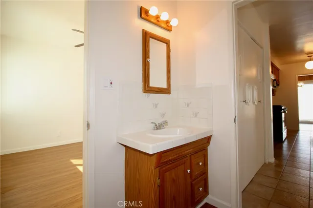 a hallway with sink and mirror