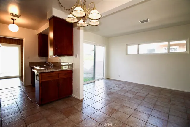 a kitchen with stainless steel appliances granite countertop a stove and a refrigerator