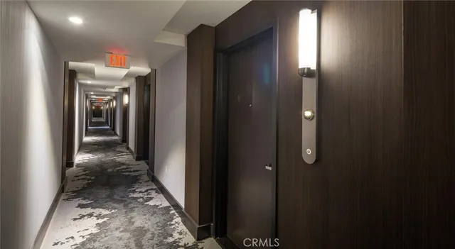 a view of a hallway view with wooden floor and living room