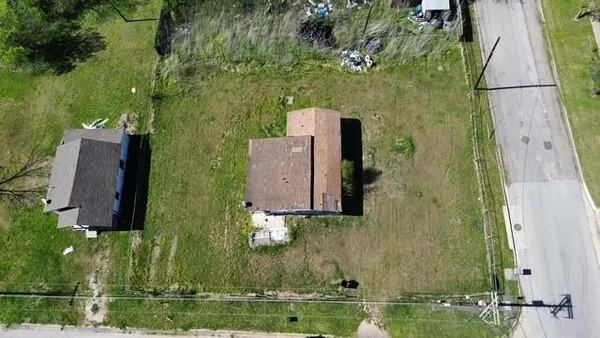 an aerial view of a house with a yard
