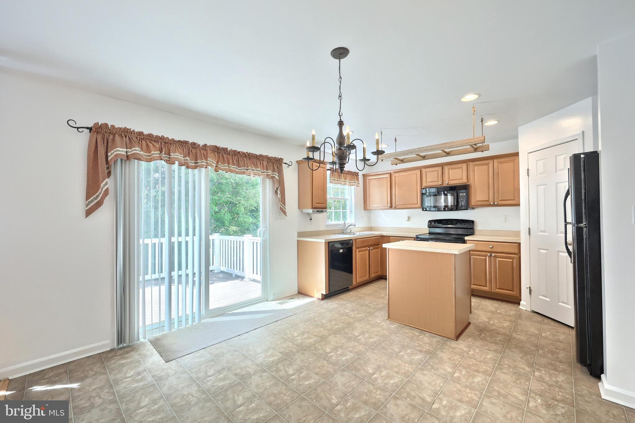 425 Lakeview Drive Spring Grove, PA 17362 - Photo 24 of 51 a open kitchen with stainless steel appliances granite countertop a refrigerator a sink dishwasher a stove and a dining table with the view of kitchen