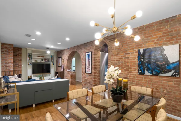 a living room with fireplace furniture and a flat screen tv
