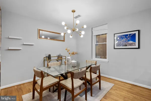 a view of a dining room with furniture and wooden floor