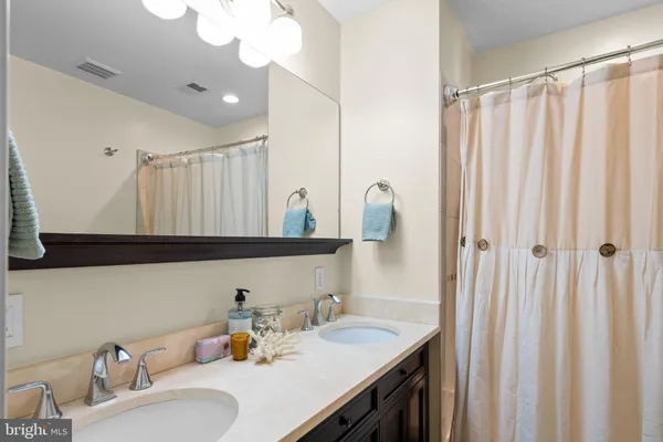 a bathroom with a sink vanity and mirror