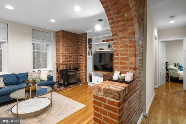 a living room with fireplace furniture and a flat screen tv