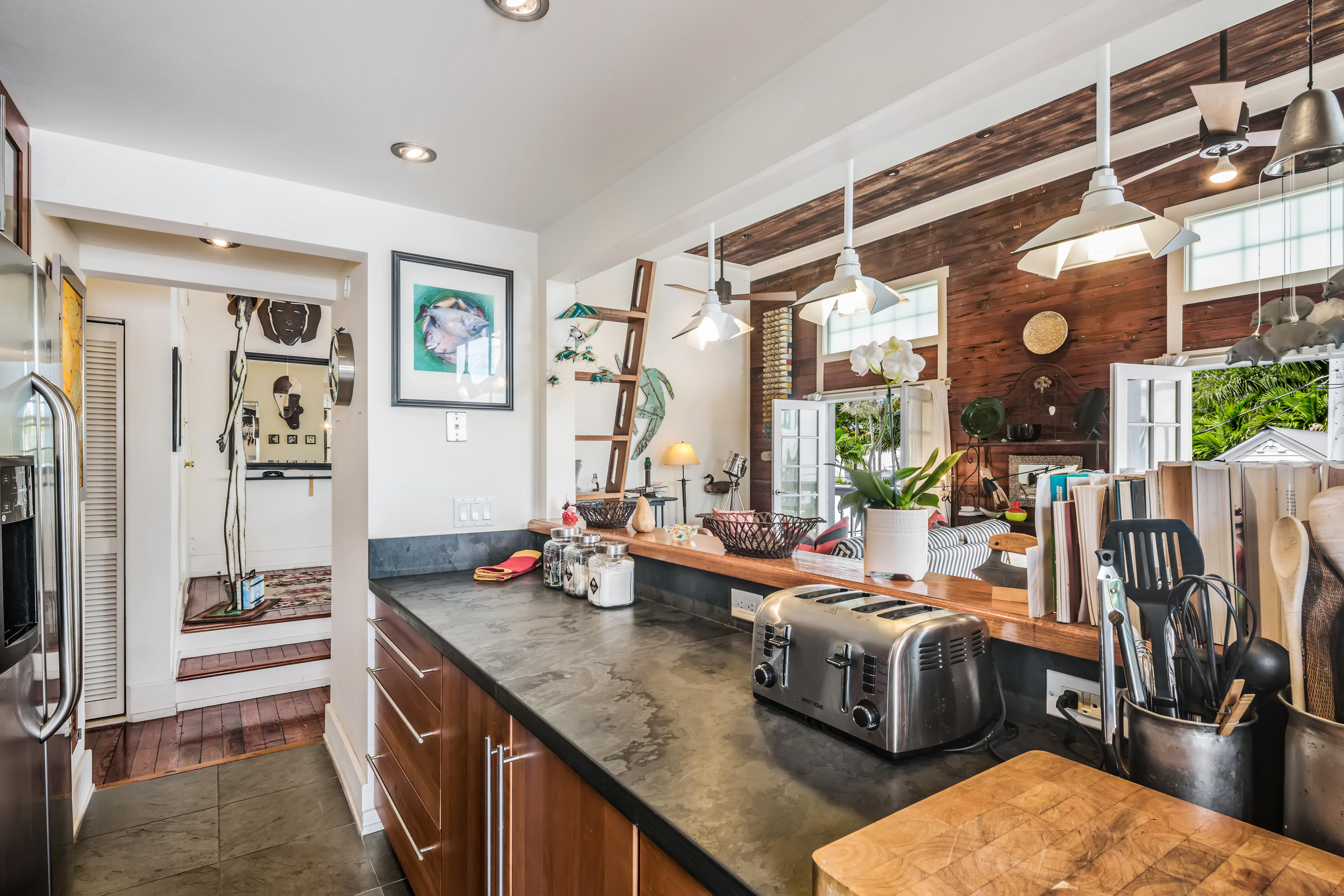 800 Fleming Street, Unit C2 Key West, FL 33040 - Photo 19 of 41 a kitchen with stainless steel appliances kitchen island granite countertop a sink and cabinets