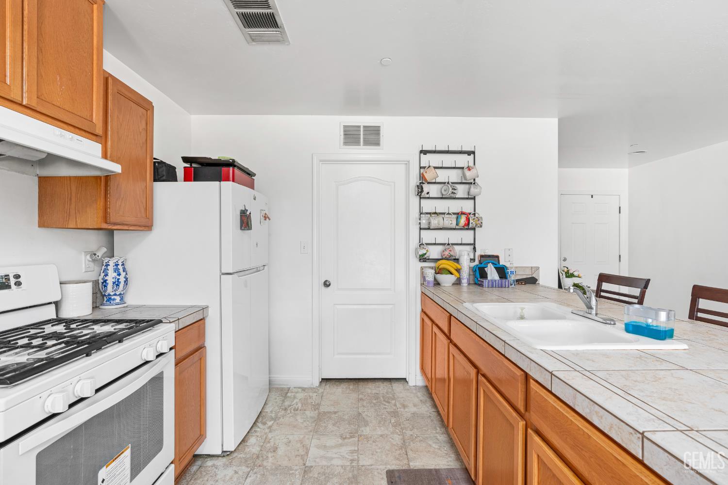 Undisclosed Address Bakersfield, CA 93306 - Photo 13 of 30 a kitchen with stainless steel appliances a sink and a refrigerator