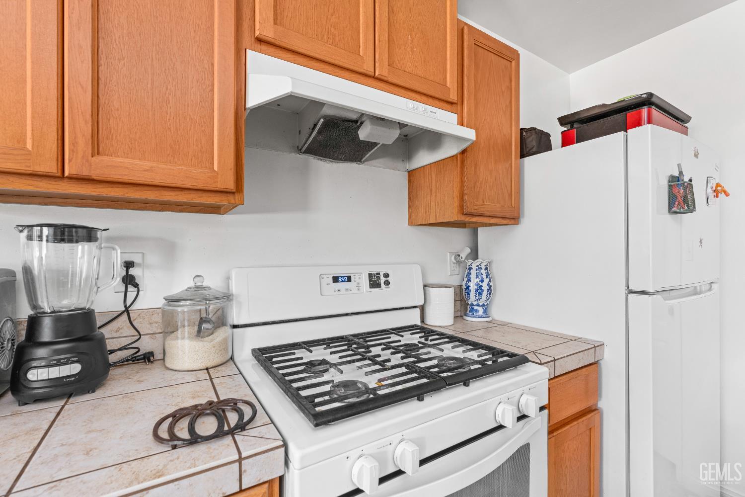 Undisclosed Address Bakersfield, CA 93306 - Photo 14 of 30 a kitchen with a stove and a white refrigerator