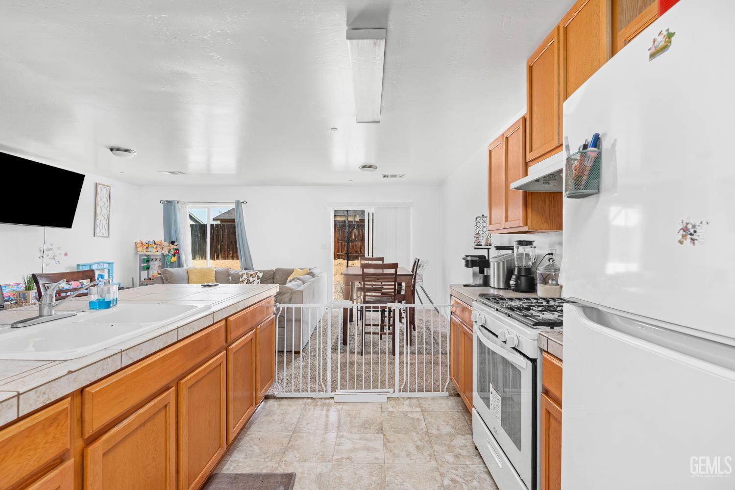 Undisclosed Address Bakersfield, CA 93306 - Photo 17 of 30 a kitchen with stainless steel appliances a stove top oven a sink a counter space and cabinets