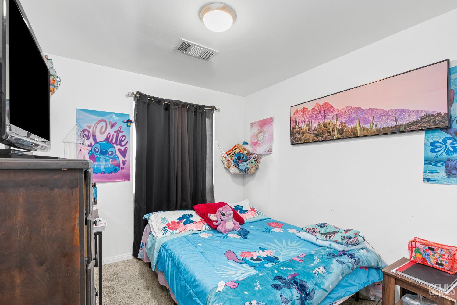 Undisclosed Address Bakersfield, CA 93306 - Photo 19 of 30 a bedroom with a bed a wall painting and a picture on the wall