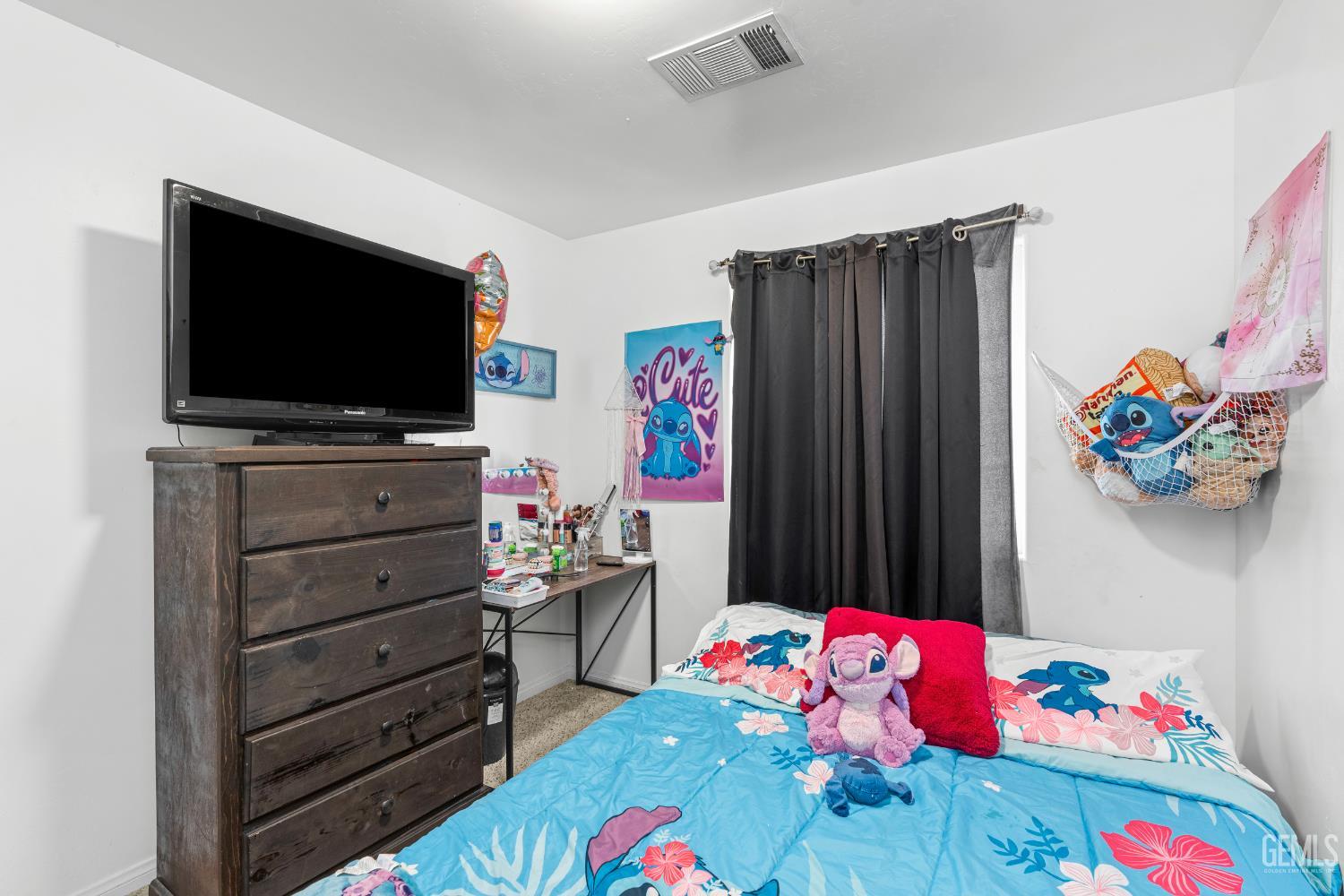 Undisclosed Address Bakersfield, CA 93306 - Photo 20 of 30 a living room with toys and flat screen tv