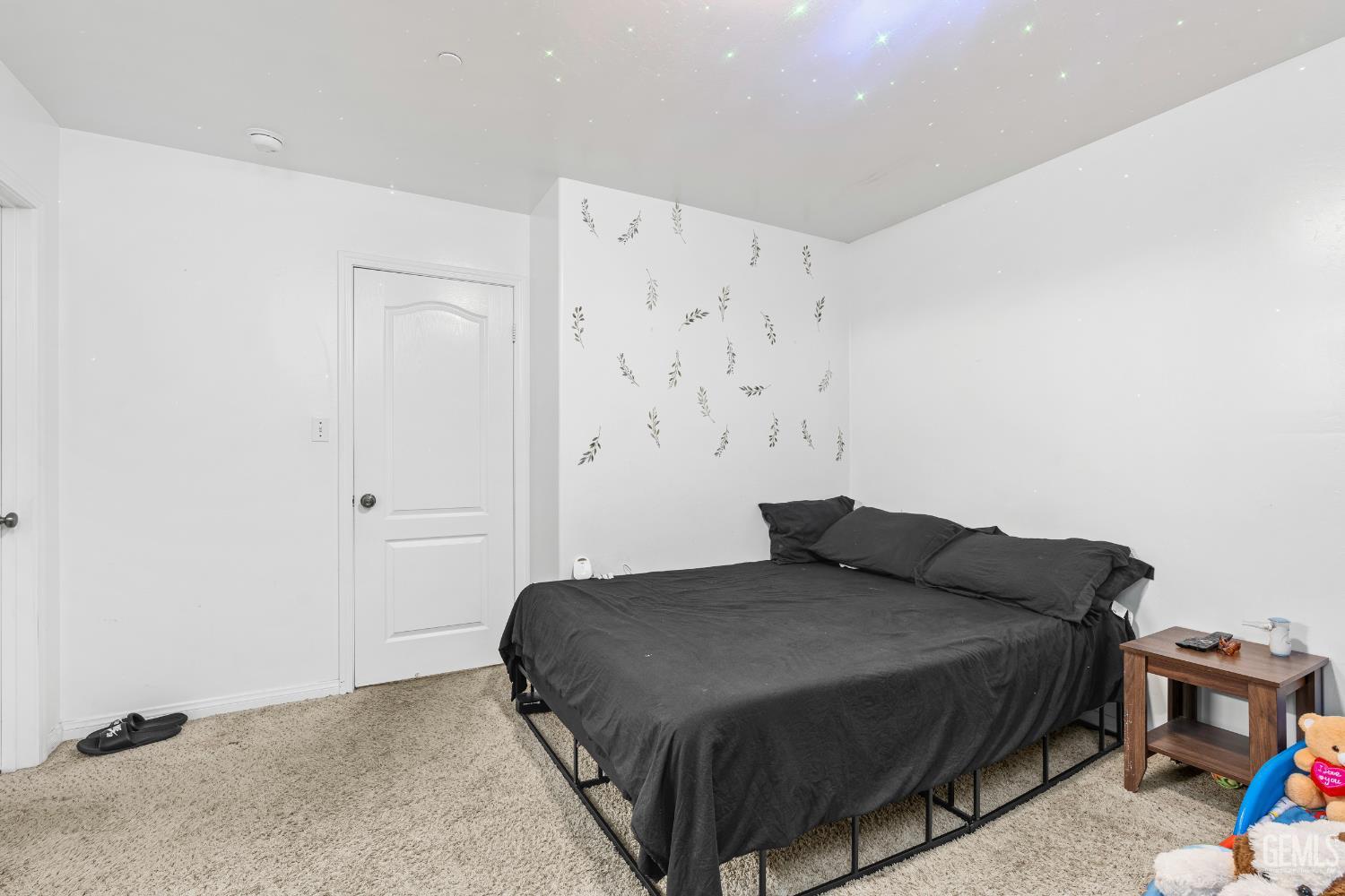 Undisclosed Address Bakersfield, CA 93306 - Photo 26 of 30 a bedroom with a bed and a wall painting