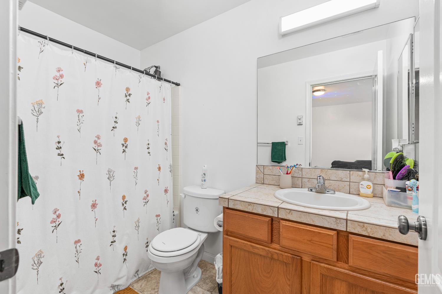 Undisclosed Address Bakersfield, CA 93306 - Photo 28 of 30 a bathroom with a granite countertop sink a toilet and a mirror