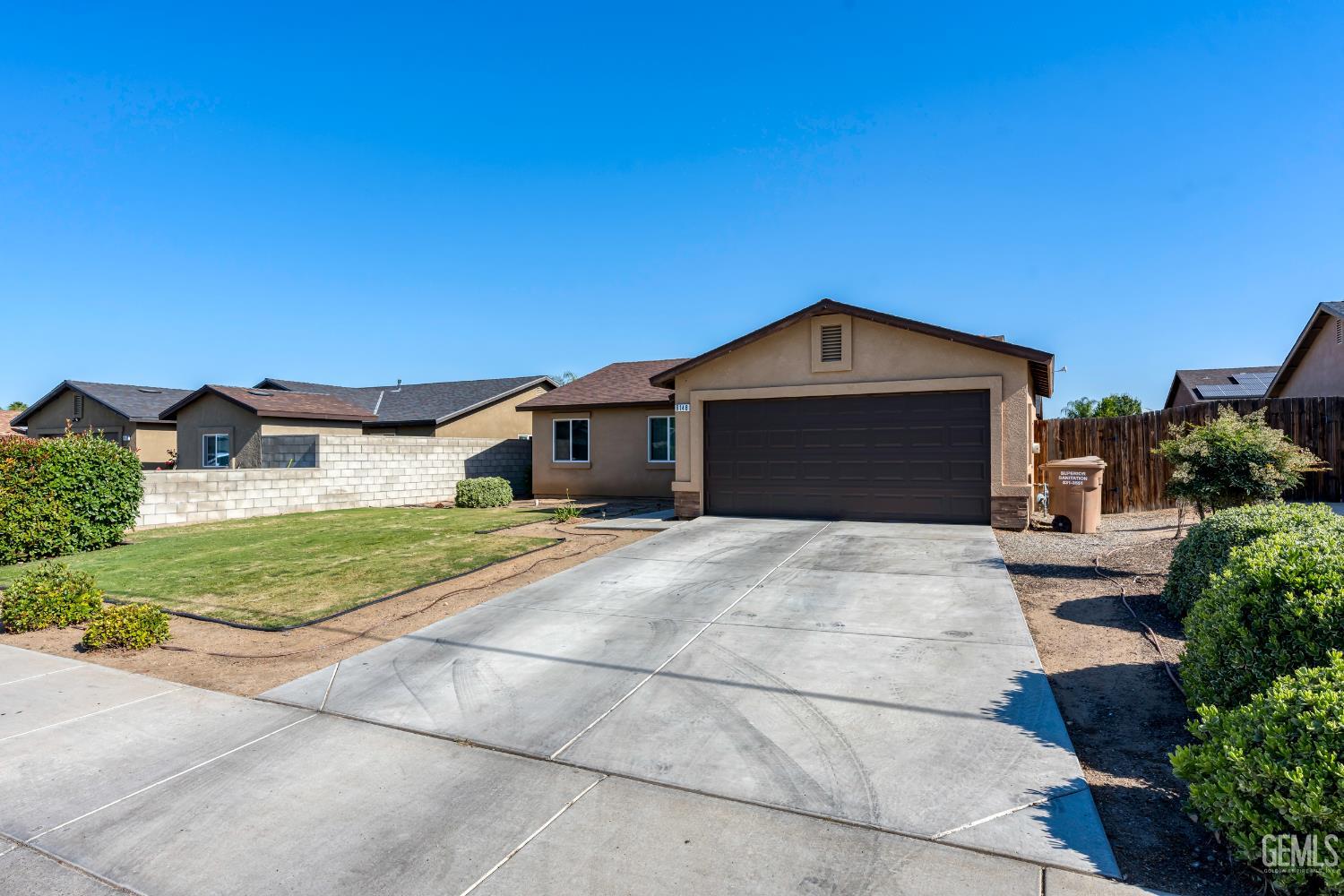 Undisclosed Address Bakersfield, CA 93306 - Photo 3 of 30 a front view of a house with a yard and garage