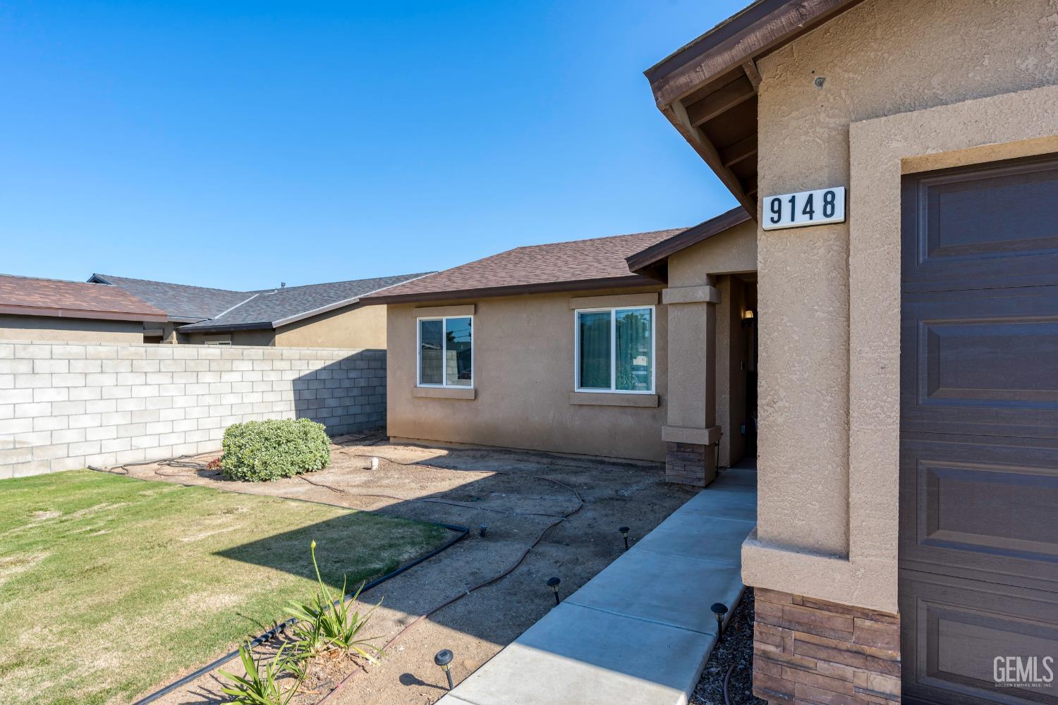 Undisclosed Address Bakersfield, CA 93306 - Photo 4 of 30 a front view of a house with garden