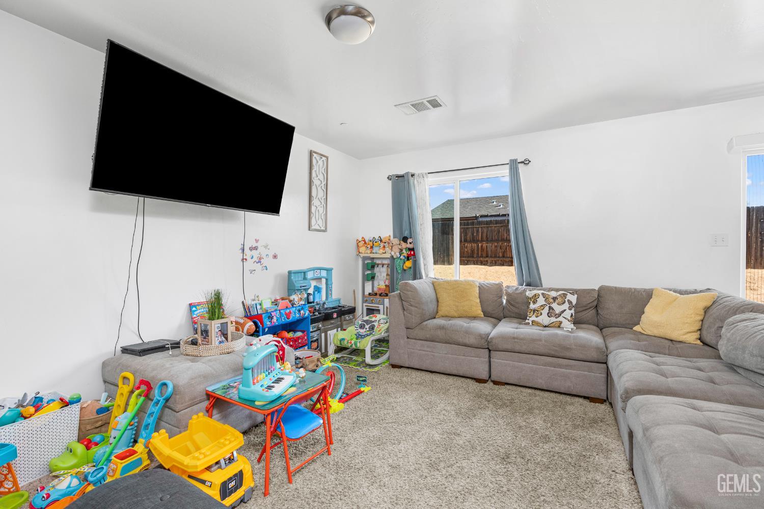 Undisclosed Address Bakersfield, CA 93306 - Photo 8 of 30 a living room with furniture and a flat screen tv