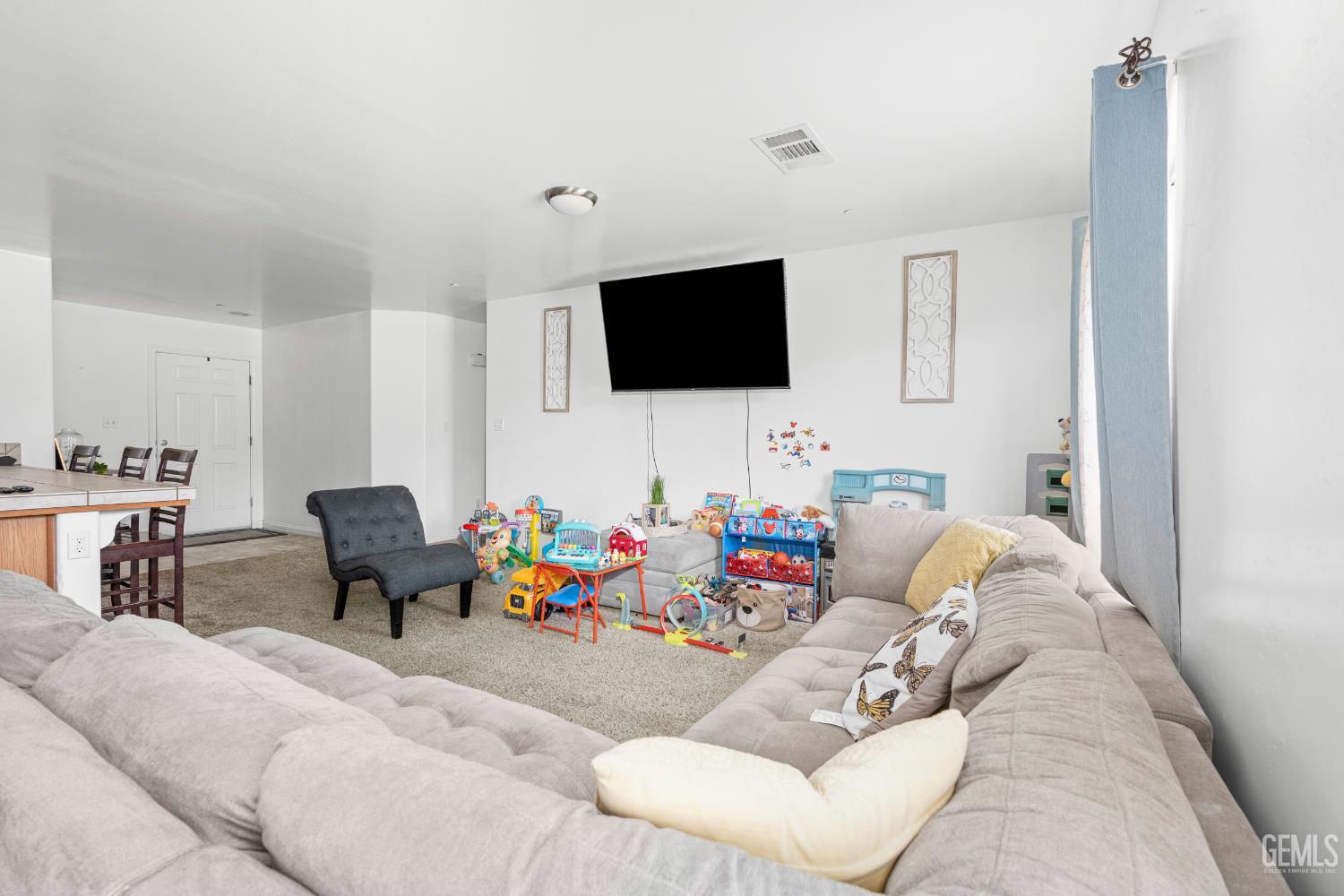 Undisclosed Address Bakersfield, CA 93306 - Photo 9 of 30 a living room with furniture and a flat screen tv