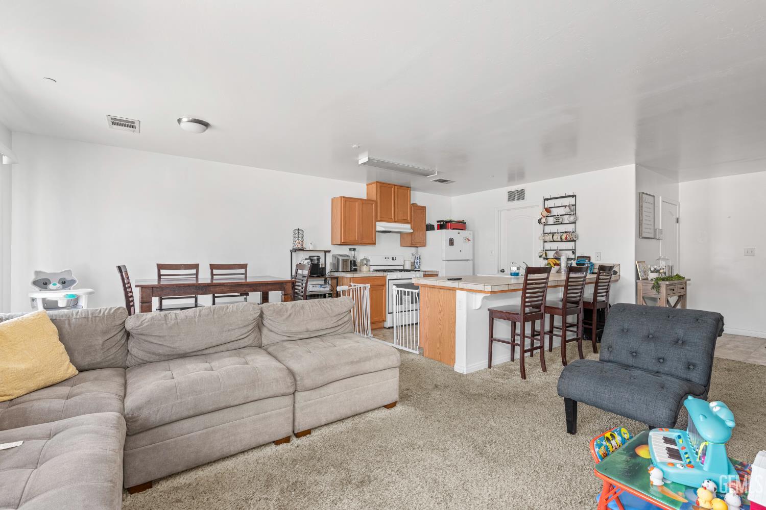 Undisclosed Address Bakersfield, CA 93306 - Photo 10 of 30 a living room with furniture and a dining table with kitchen view