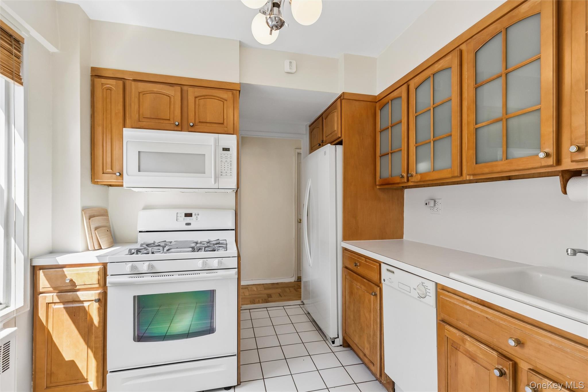 110-20 71st Road, Unit 707 Queens, NY 11375 - Photo 6 of 12 Windowed kitchen features dishwasher, microwave and refrigerator with water feature