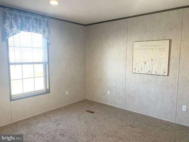 a view of kitchen with furniture and refrigerator