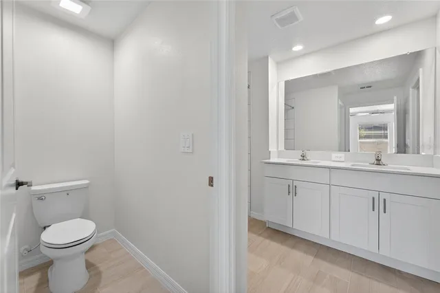 a bathroom with a toilet a sink and mirror