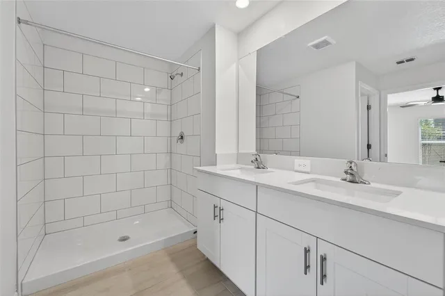 a bathroom with a shower sink and mirror