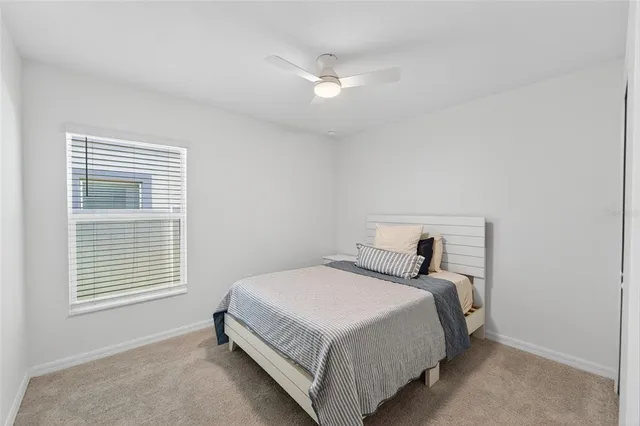 a bedroom with a bed and a large window