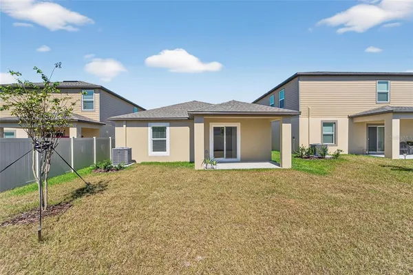 a view of a house with a backyard and porch