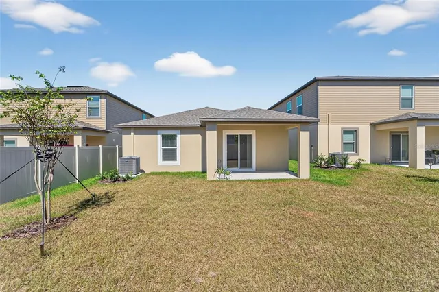 a view of a house with a backyard and porch
