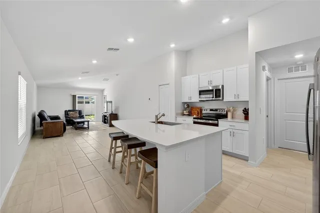 a kitchen with refrigerator and cabinets