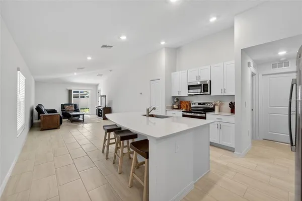 a kitchen with refrigerator and cabinets