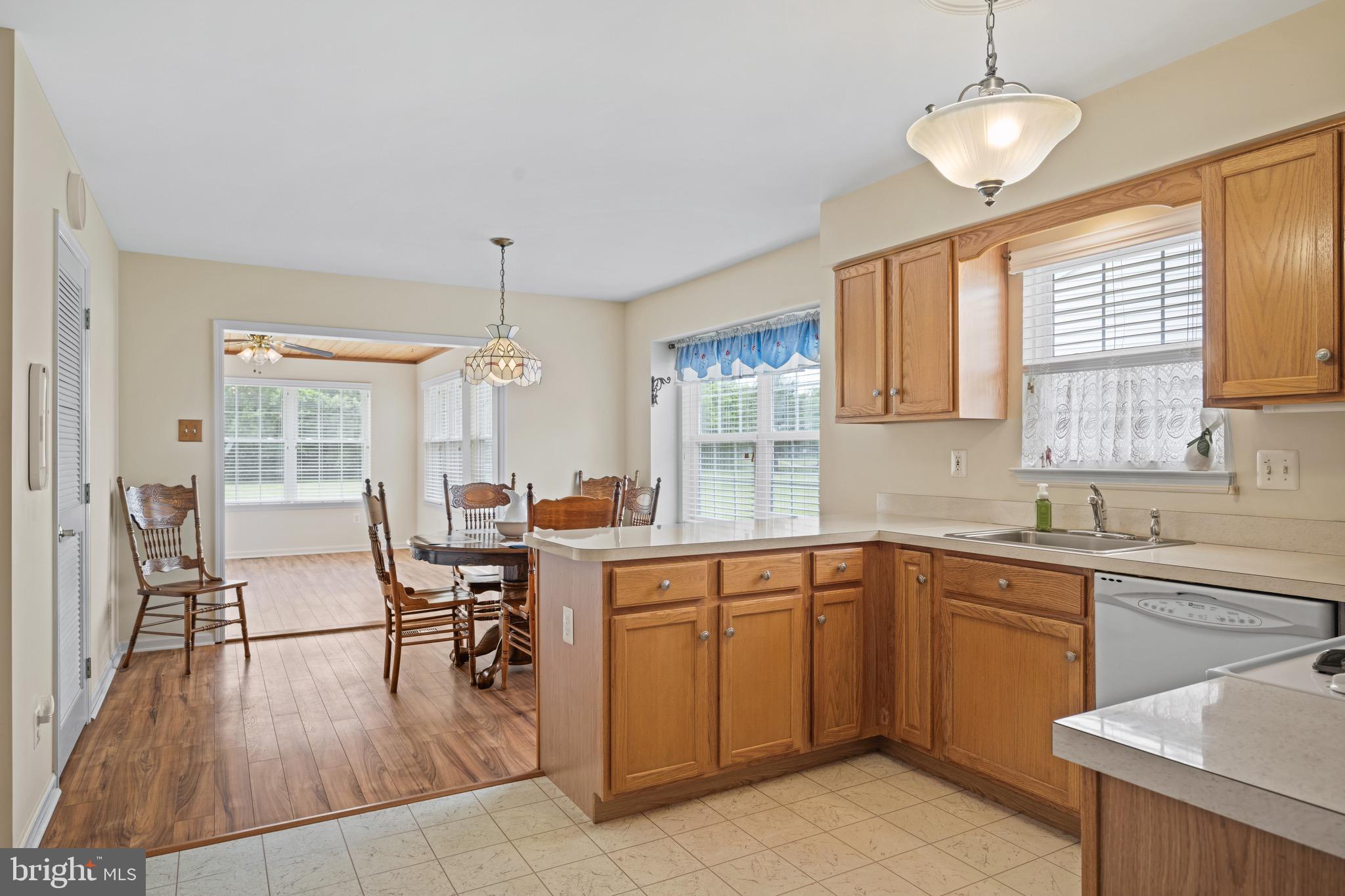 231 Gaunt Drive Mickleton, NJ 08056 - Photo 8 of 28 a kitchen with a table chairs sink and cabinets