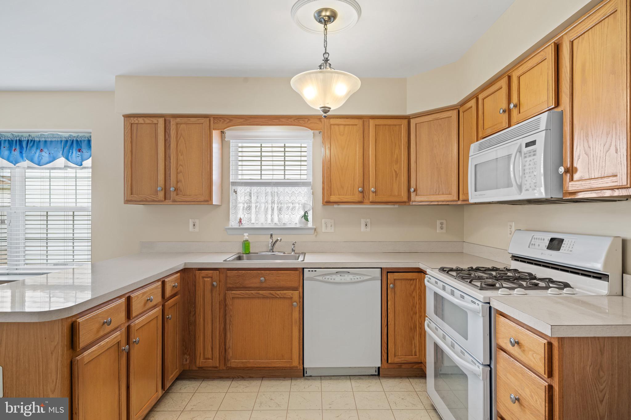 231 Gaunt Drive Mickleton, NJ 08056 - Photo 9 of 28 a kitchen with stainless steel appliances granite countertop a sink stove and cabinets