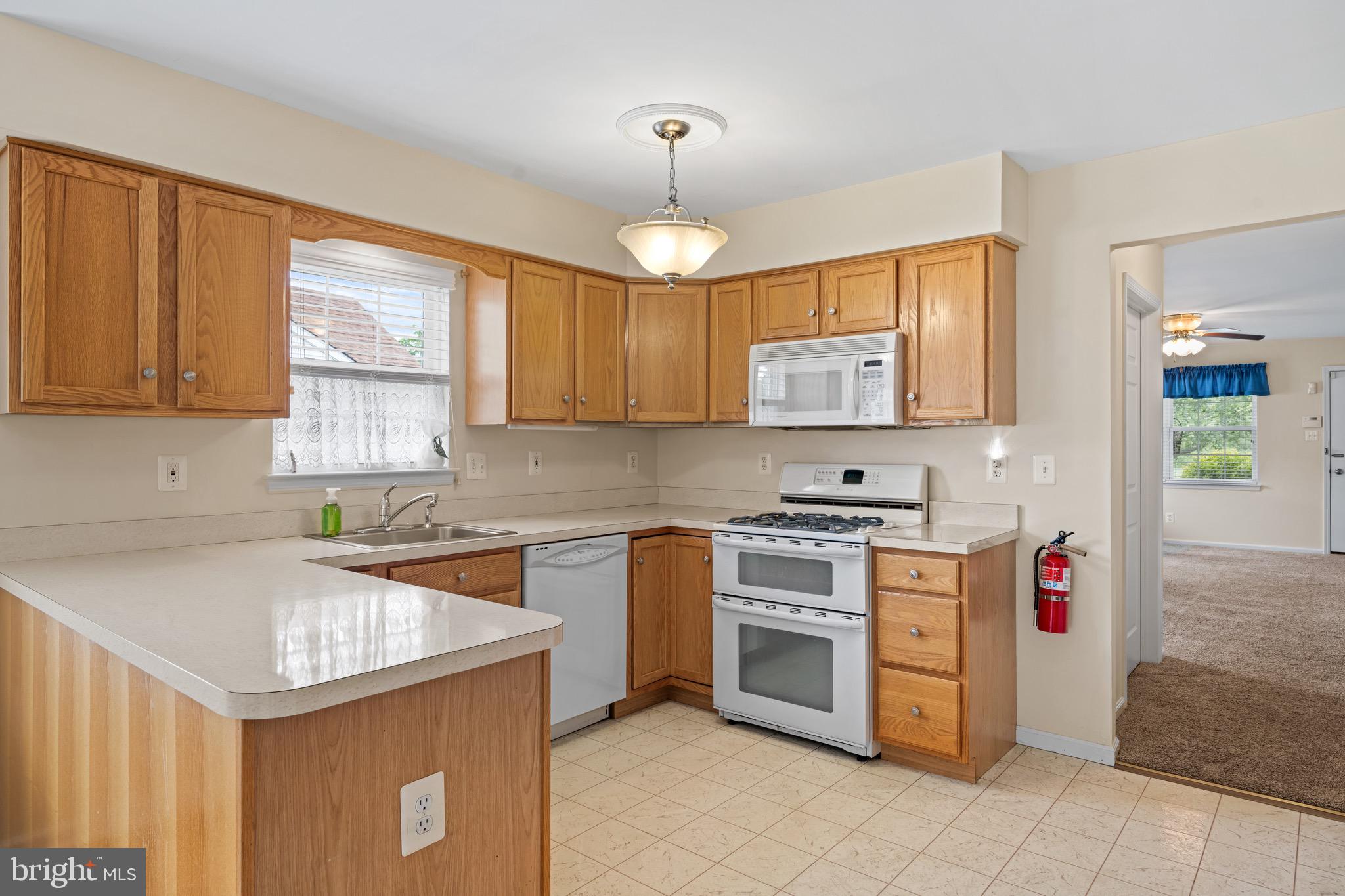 231 Gaunt Drive Mickleton, NJ 08056 - Photo 10 of 28 a kitchen that has a sink and a stove