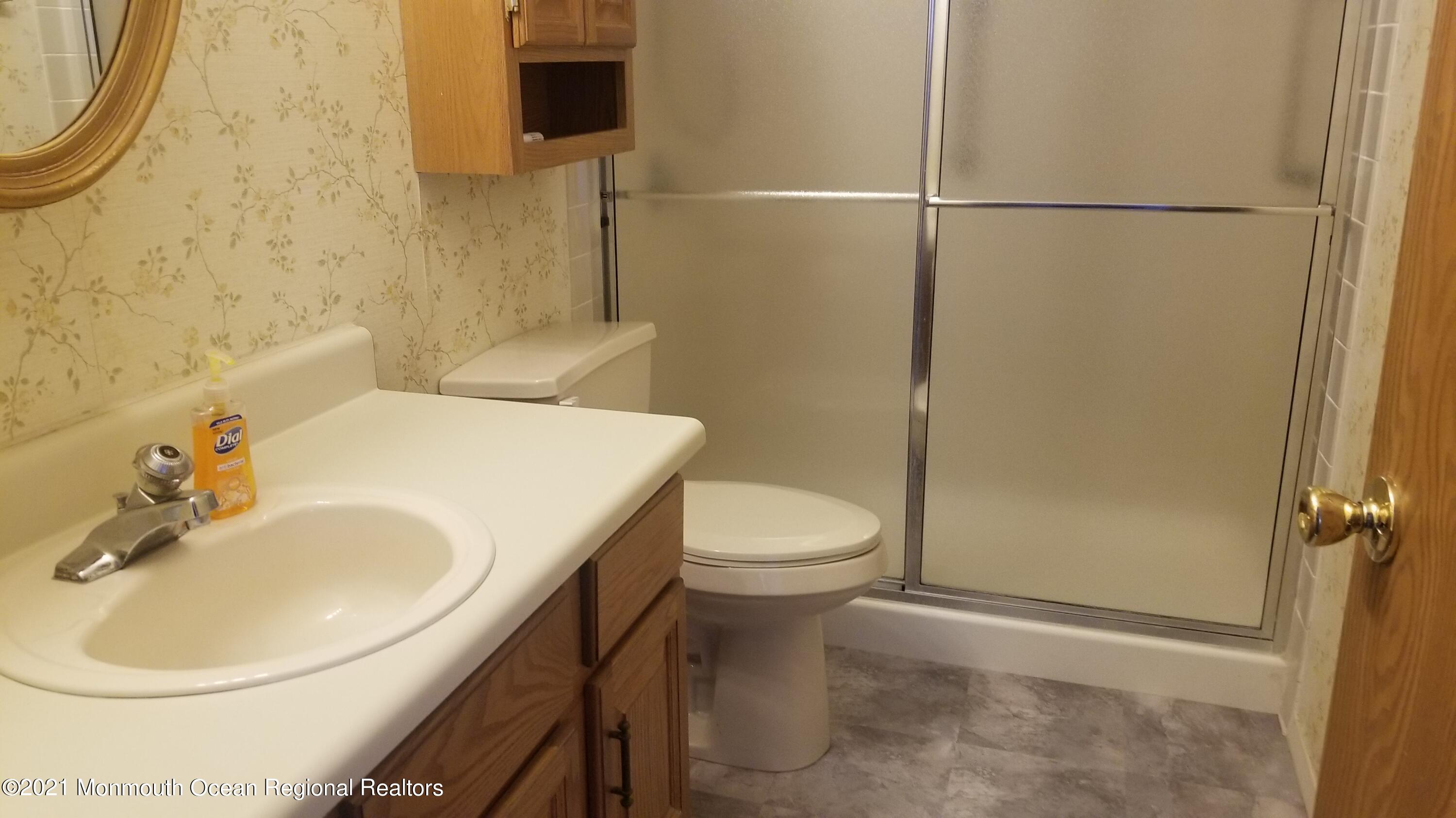 20D Ashley Road, Unit A Whiting, NJ 08759 - Photo 23 of 29 a bathroom with a sink a toilet and shower