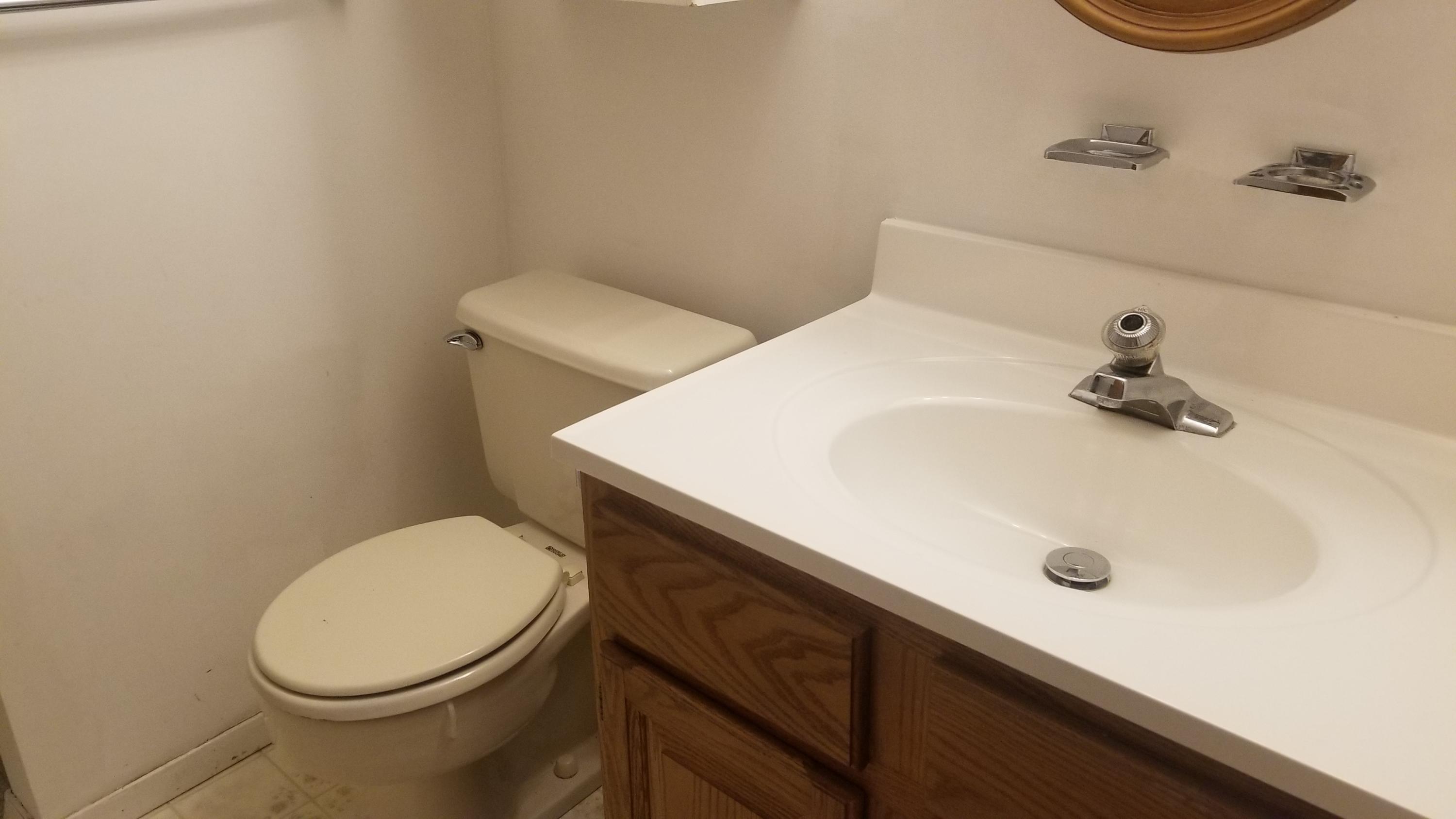20D Ashley Road, Unit A Whiting, NJ 08759 - Photo 24 of 29 a bathroom with a sink and a toilet