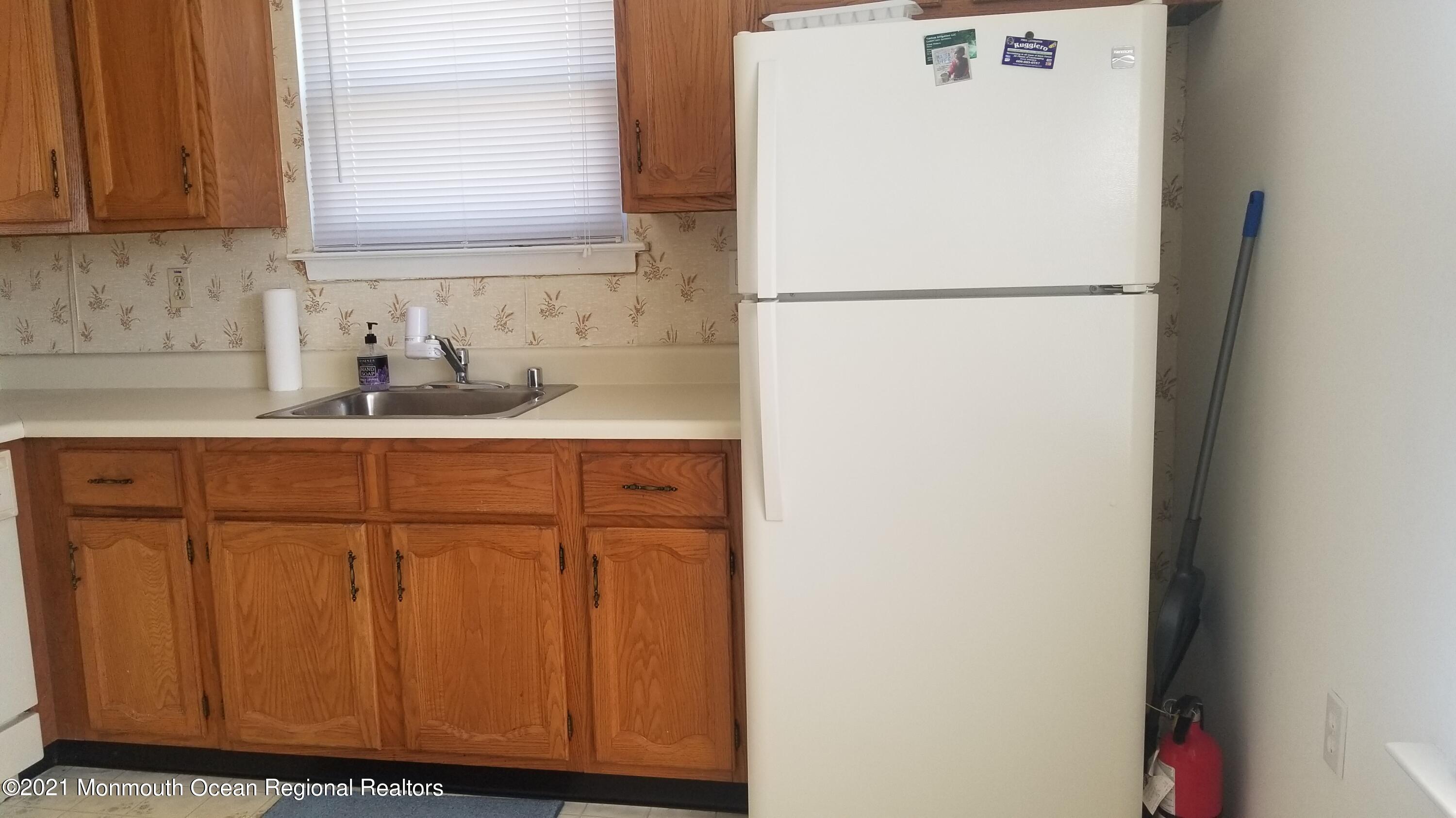 20D Ashley Road, Unit A Whiting, NJ 08759 - Photo 8 of 29 a white refrigerator freezer sitting inside of a kitchen