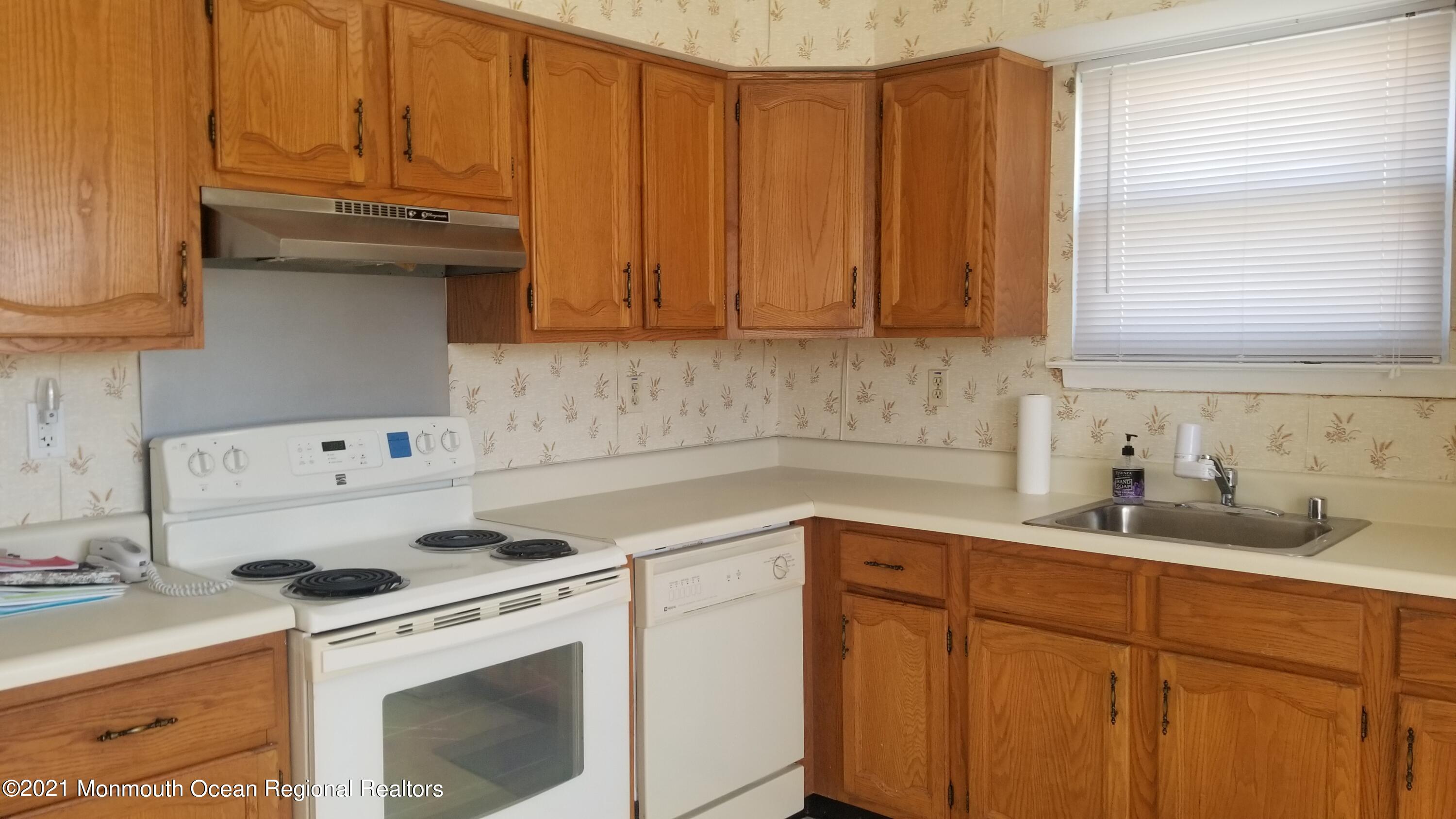 20D Ashley Road, Unit A Whiting, NJ 08759 - Photo 10 of 29 a kitchen with a sink a stove and cabinets