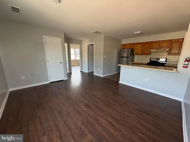 a kitchen with a refrigerator a stove a sink and a window