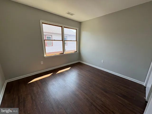 a bathroom with a sink a toilet a mirror and shower