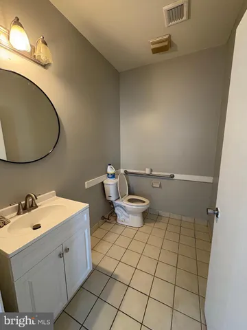 a living room with furniture and a toilet