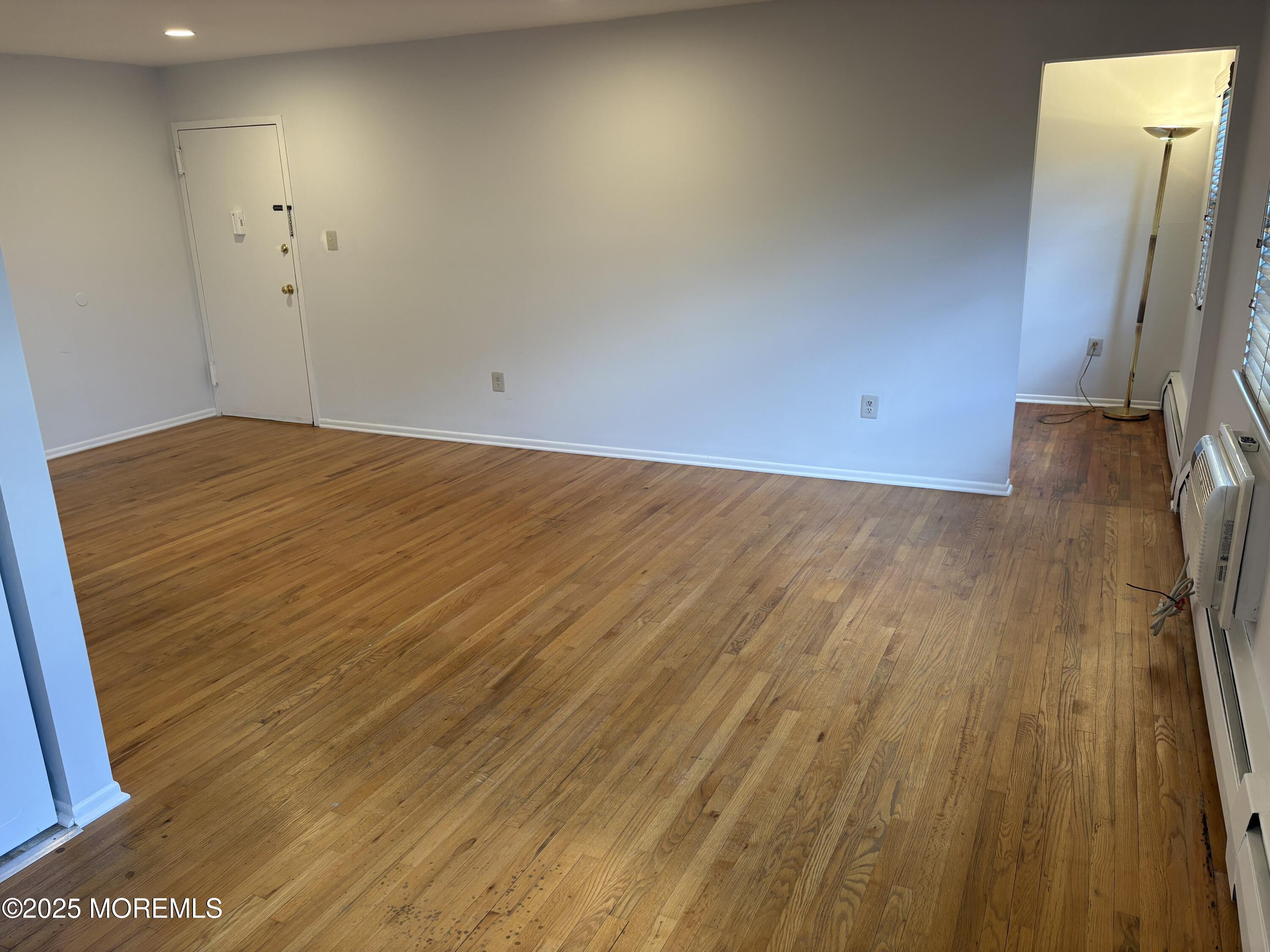 94 Stonehurst Boulevard, Unit E Freehold, NJ 07728 - Photo 2 of 11 a view of a room with wooden floor